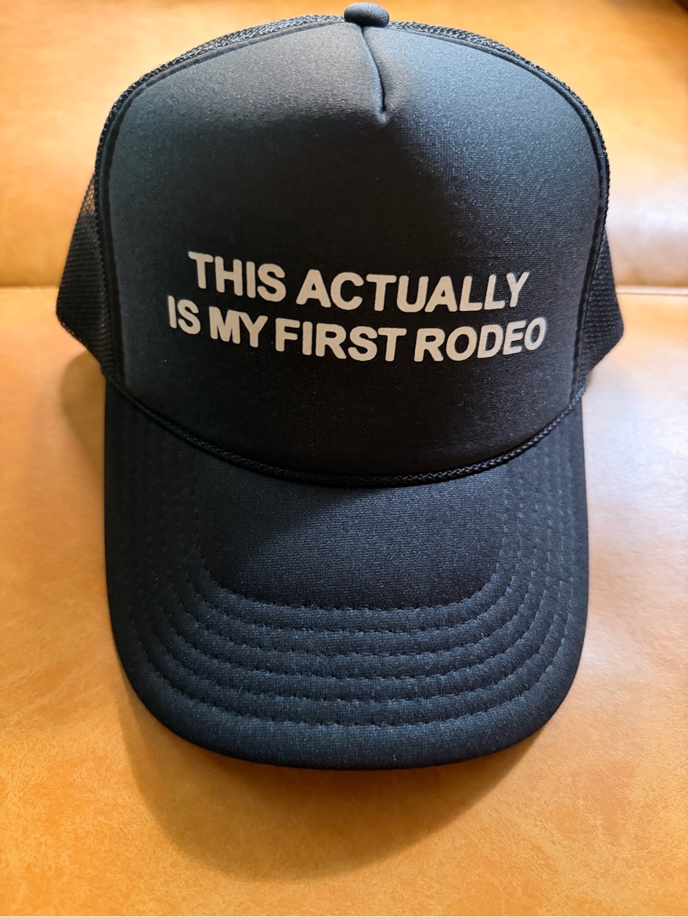 Black Trucker Cap with "This Actually Is My First Rodeo" Text